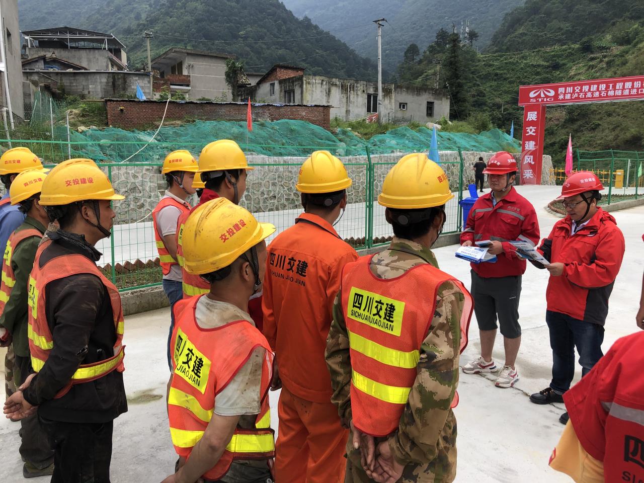 瀘石TJ10項目部相關(guān)負(fù)責(zé)人向農(nóng)民工宣讀普法知識.jpg